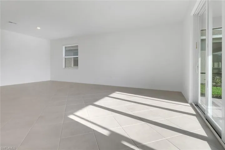 Unfurnished room with light tile patterned flooring, visible vents, and recessed lighting