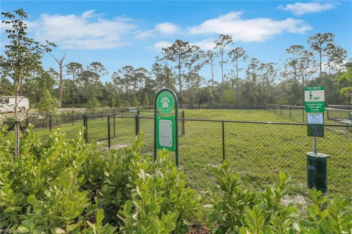Surrounding community with fence and a lawn