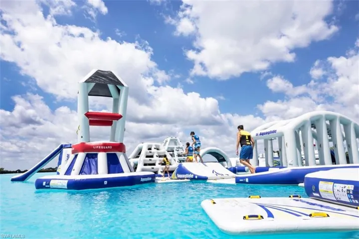 Pool with a water slide and a water play area