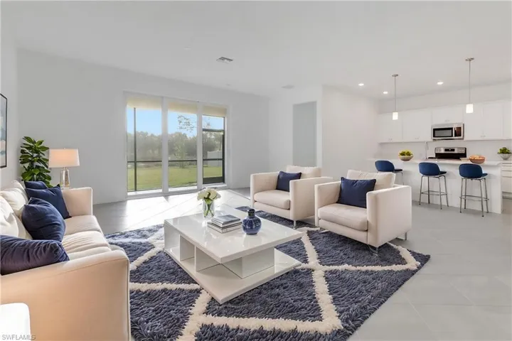 Living area featuring light tile patterned floors, visible vents, and recessed lighting