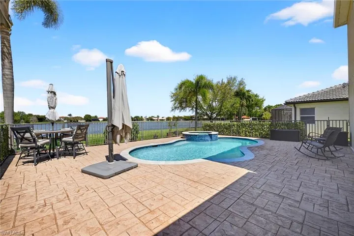 Relaxing pool / spa featuring a patio, a fenced backyard, and outdoor dining area.