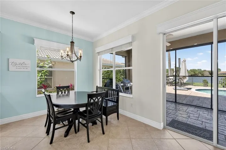 Dining area featuring ornamental molding, healthy amount of natural light and a water view.
