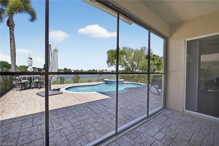 Covered screened in lanai and outdoor dining space.