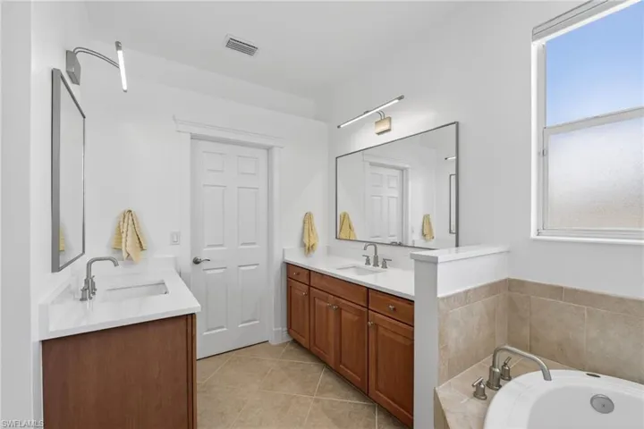 Full bathroom featuring two vanities.