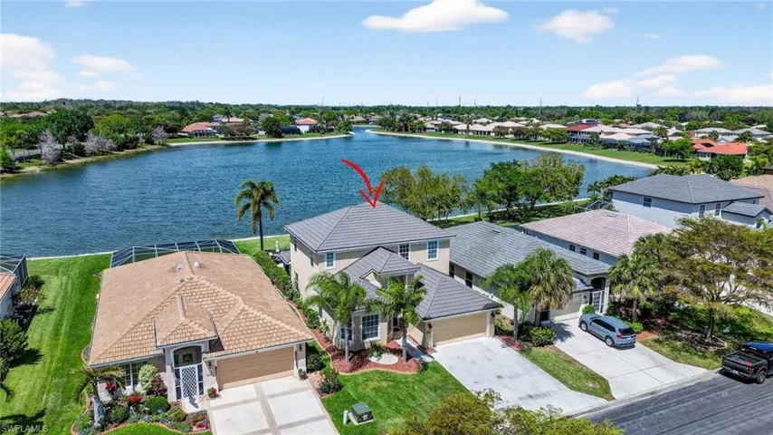 Aerial perspective of suburban area with a nearby body of water