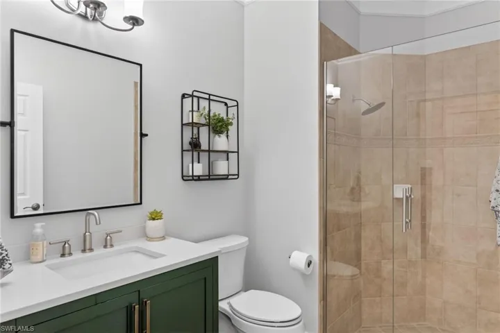 Downstairs full bathroom featuring updated vanity and shower.