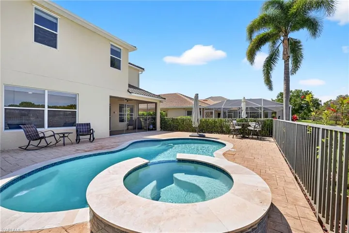Integrated pool / hot tub with a patio, outdoor dining space.