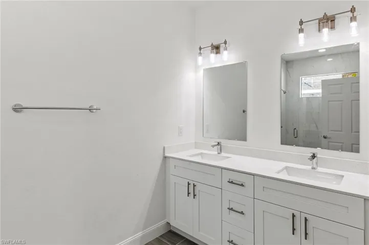 Bathroom with a shower with door and double sink vanity
