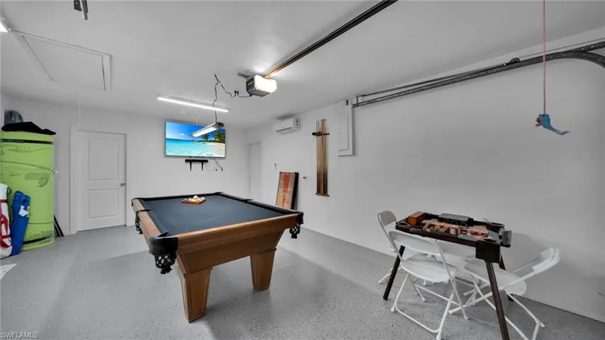 Rec room featuring billiards, attic access, and a garage