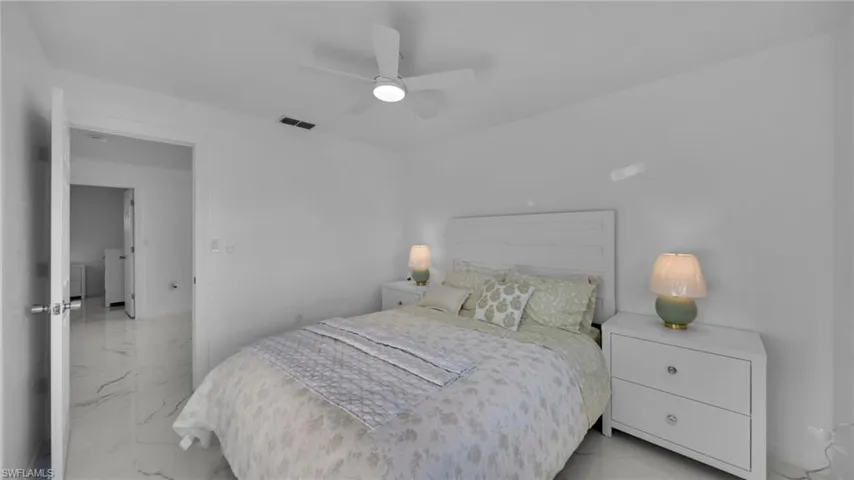 Bedroom featuring marble finish flooring and a ceiling fan