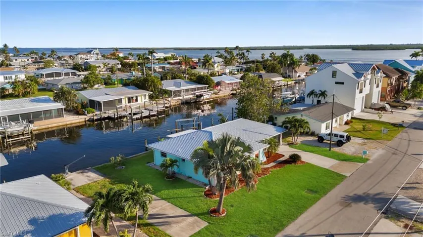 Aerial view of residential area featuring a large body of water