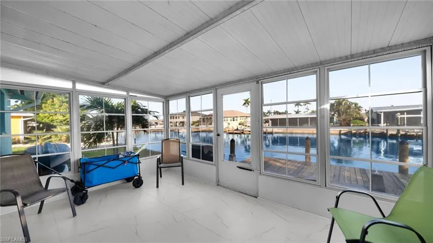 Sunroom / solarium with a water view and healthy amount of natural light
