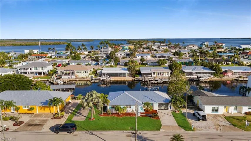 Aerial perspective of suburban area with a nearby body of water