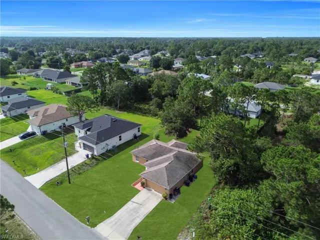 Aerial perspective of a residential neighborhood with a mix of established and new construction homes