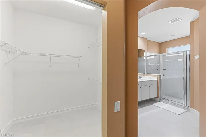 Walk in closet and primary bathroom