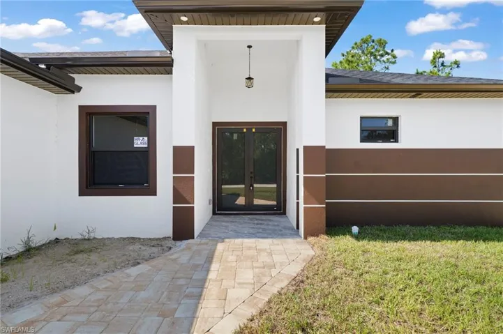 Property entrance featuring a yard and french doors