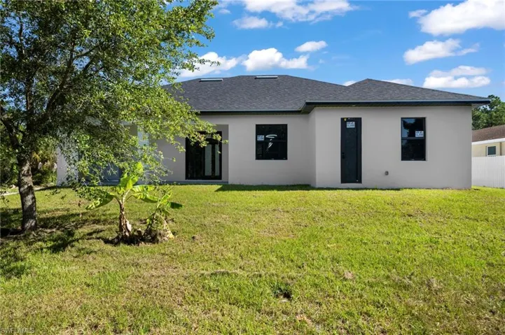 Back of house featuring a lawn