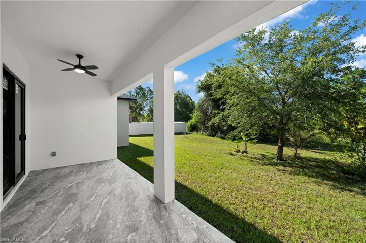 View of yard featuring a patio area and ceiling fan