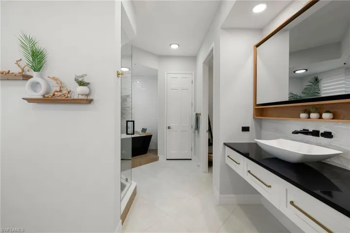 Primary bathroom featuring tile patterned flooring, vanity, and independent shower and bath