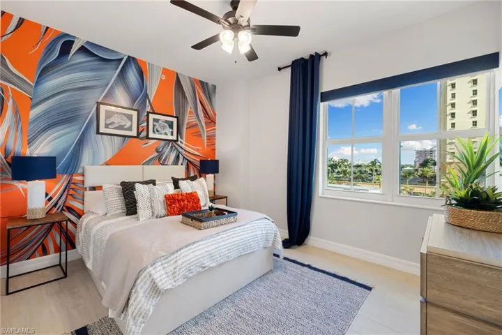 Guest bedroom featuring light wood-type flooring and ceiling fan