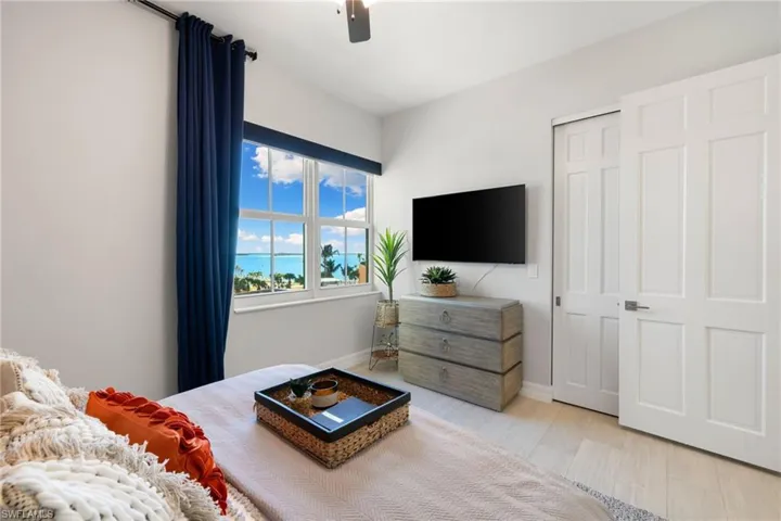 Guest bedroom featuring ceiling fan, a closet, and light hardwood / wood-style floors