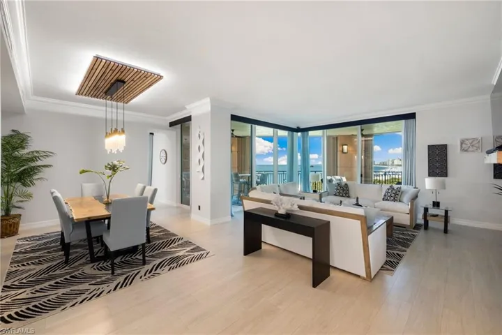 Family room with floor to ceiling windows, light hardwood / wood-style floors, and crown molding