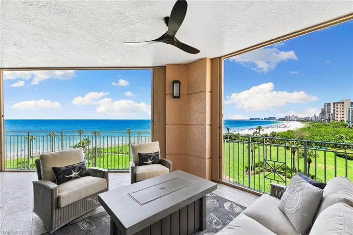 Balcony with ceiling fan, a water view and beach view, with an  outdoor lounging area