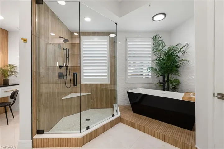 Primary bathroom featuring tile patterned flooring and shower with separate bathtub