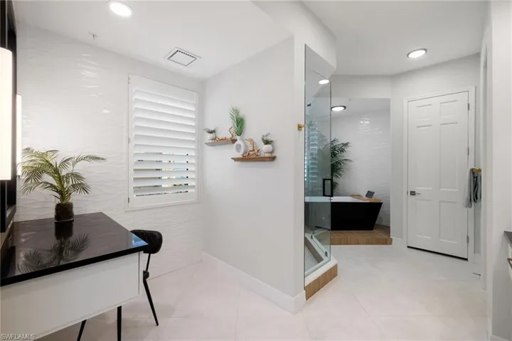 Primary bathroom with tile patterned flooring and independent shower and bath