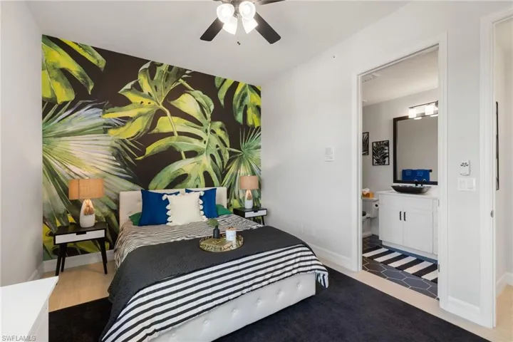 Guest bedroom with ceiling fan and light hardwood / wood-style floors