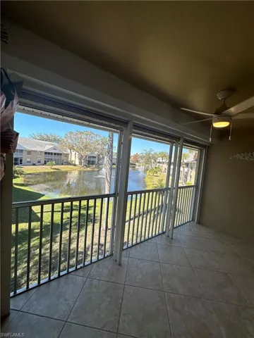 screened Balcony with ceiling fan, and a water view