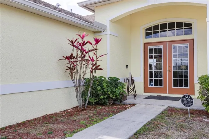 Front entry features double french doors