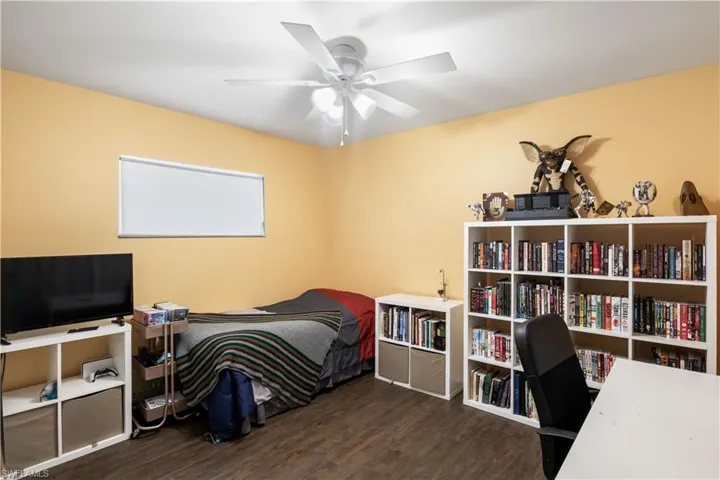 Bedroom featuring dark hardwood / wood-style floors and ceiling fan