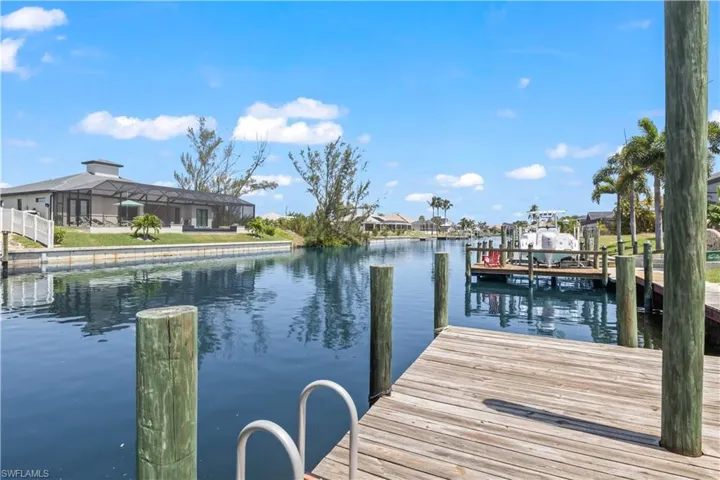 View of dock with a water view and a lanai