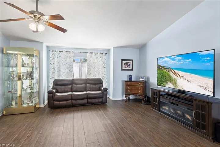 Living room featuring ceiling fan and dark hardwood / wood-style floors