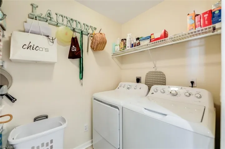 Laundry area featuring laundry area, separate washer and dryer, and baseboards