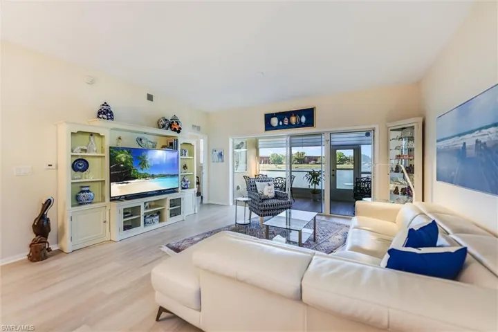 Living area featuring light wood-type flooring, visible vents, and baseboards