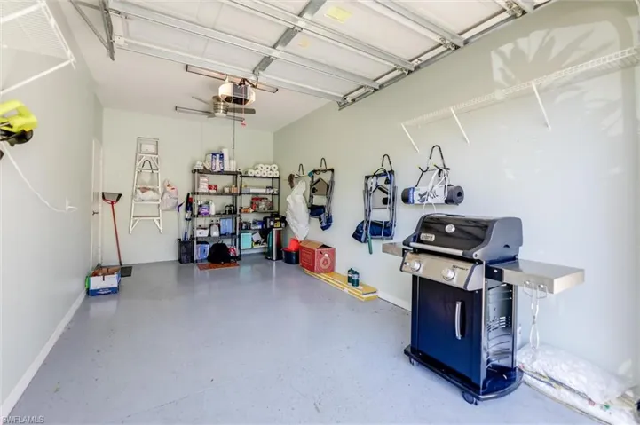 Garage with a garage door opener and baseboards