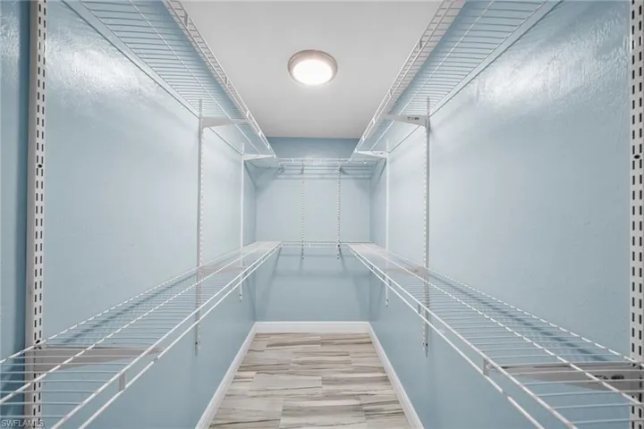 Walk in closet featuring light wood-type flooring