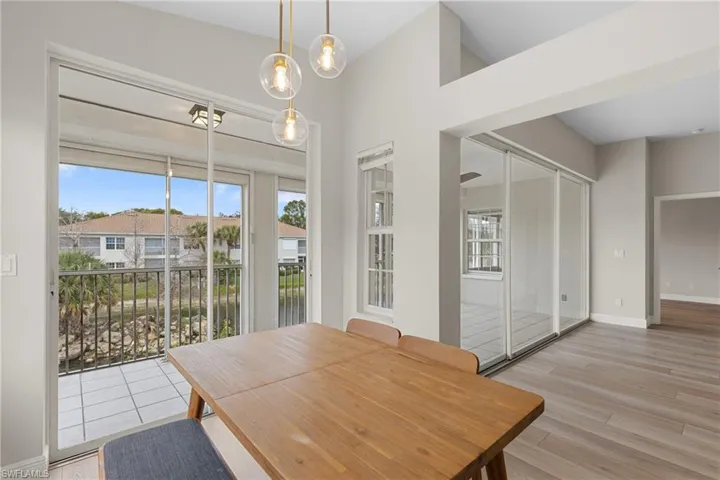 Dining area featuring light hardwood / wood-style floors and vaulted ceiling