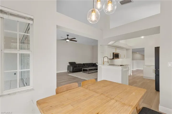 Dining room with ceiling fan, light hardwood / wood-style flooring, and sink