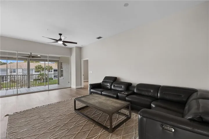 Living room featuring hardwood / wood-style flooring and ceiling fan