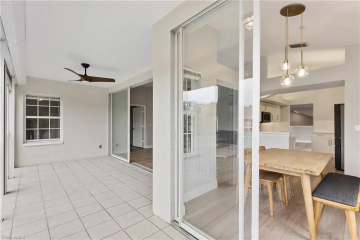 Unfurnished sunroom with ceiling fan and lofted ceiling