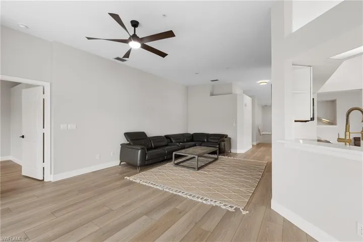 Living room featuring ceiling fan and light wood-type flooring
