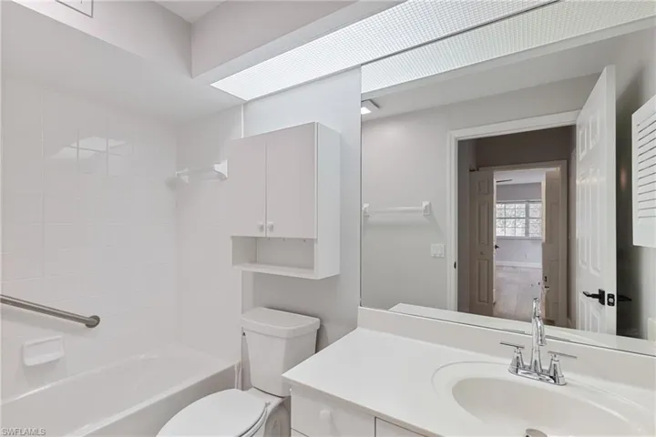 Full bathroom featuring vanity, bathing tub / shower combination, and toilet