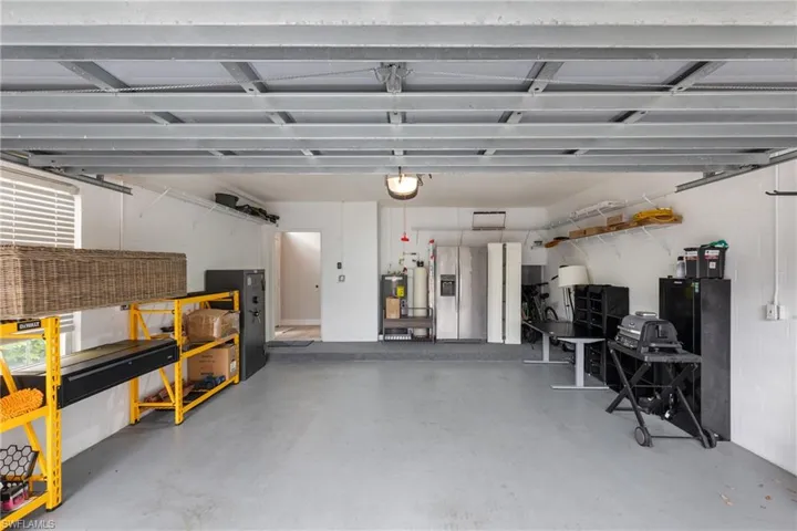 Garage featuring gas water heater and a garage door opener