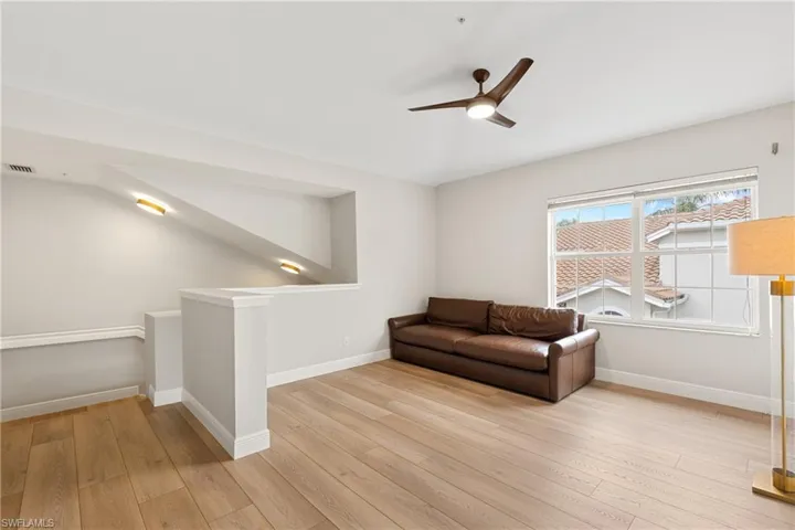 Living area featuring ceiling fan and light hardwood / wood-style floors