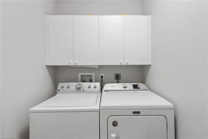 Laundry area with cabinets and independent washer and dryer