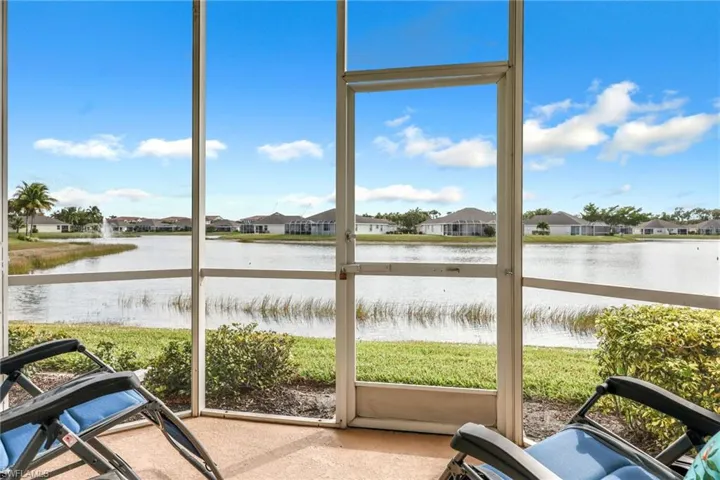 Sunroom / solarium with a residential view and a water view