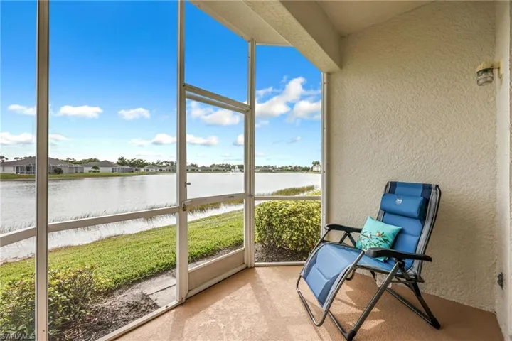 Unfurnished sunroom featuring a water view and a residential view